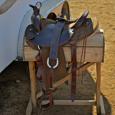 Western saddles have a multitude of straps and strings and metal rings that makes it easy to carry canteens and other items.  Photo by Charles Hood.      